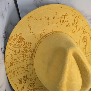 Side view of beauty and the Beast engraving Vegan Suede Hat, an engraved western fedora.
