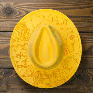 Close-up of beauty and the Beast engraving Vegan Suede Hat, an engraved western fedora.