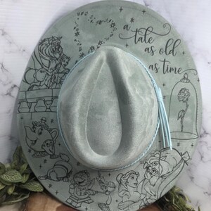 Beauty and the Beast engraving Vegan Suede Hat paired with matching props, an engraved western fedora.