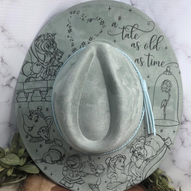 Beauty and the Beast engraving Vegan Suede Hat paired with matching props, an engraved western fedora.