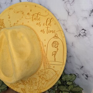 Beauty and the Beast engraving Vegan Suede Hat styled in use, an engraved western fedora.