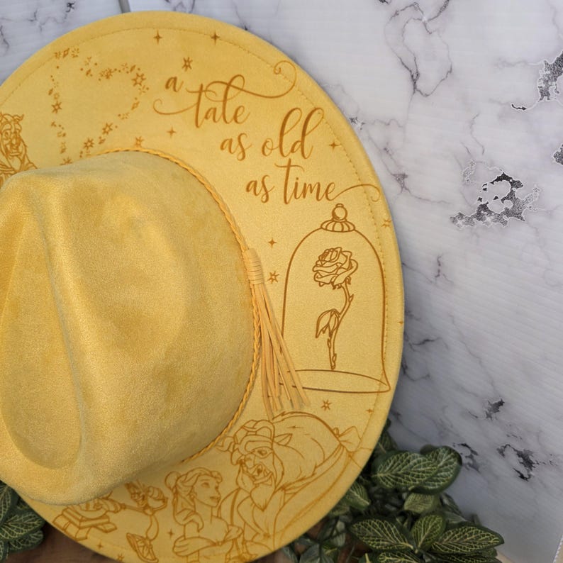 Beauty and the Beast engraving Vegan Suede Hat styled in use, an engraved western fedora.