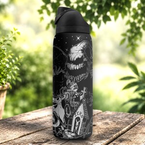 Laser engraved black stainless steel tumbler featuring spooky holiday-inspired characters, pumpkins, haunted scenes, and gothic wraparound artwork in a detailed silver engraving design.