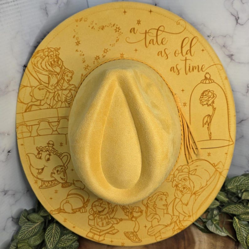 Beauty and the Beast engraving Vegan Suede Hat shown on white, an engraved western fedora.