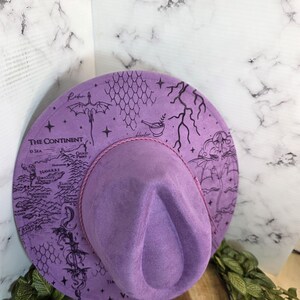 Side view of fourth Wing dragon-rider design Wide Brim Hat, a romantasy reader bookish gift.
