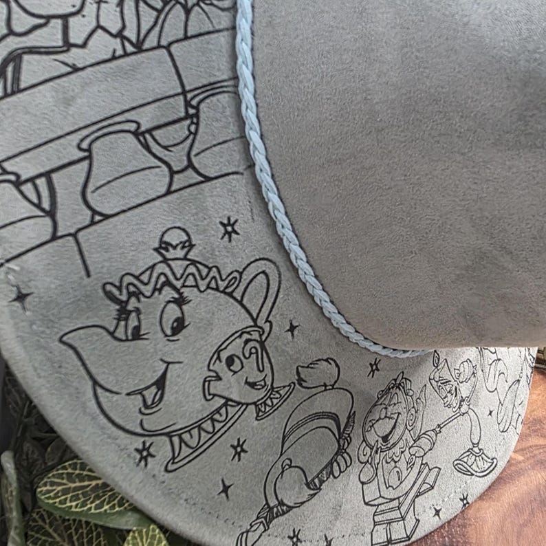 Beauty and the Beast engraving Vegan Suede Hat shown on white, an engraved western fedora.