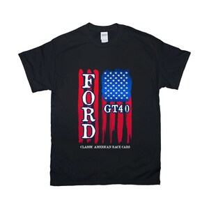 May include: Black t-shirt featuring a patriotic design with the word "FORD" in white, a blue and white star field, and red stripes resembling the American flag. The text "GT40" and "CLASSIC AMERICAN RACE CARS" are also displayed.