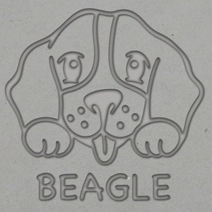 May include: Line drawing of a Beagle dog's head with the word "BEAGLE" underneath.