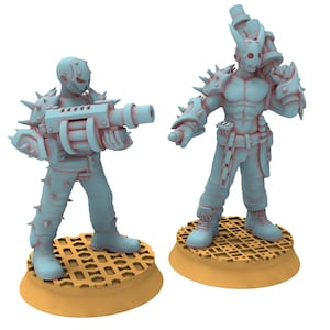 May include: Two blue plastic miniature figures with spiky armor and guns. The figures are standing on round orange bases.