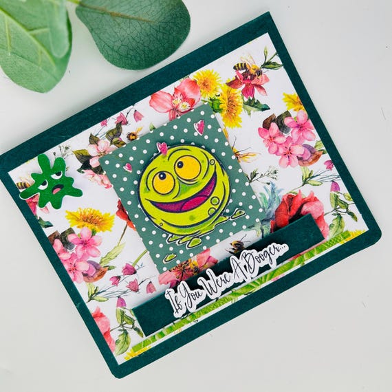 A handmade layered pop-up card where a giant green booger nose literally pops out — the kind of gross-out humor that makes kids and dads actually laugh out loud.