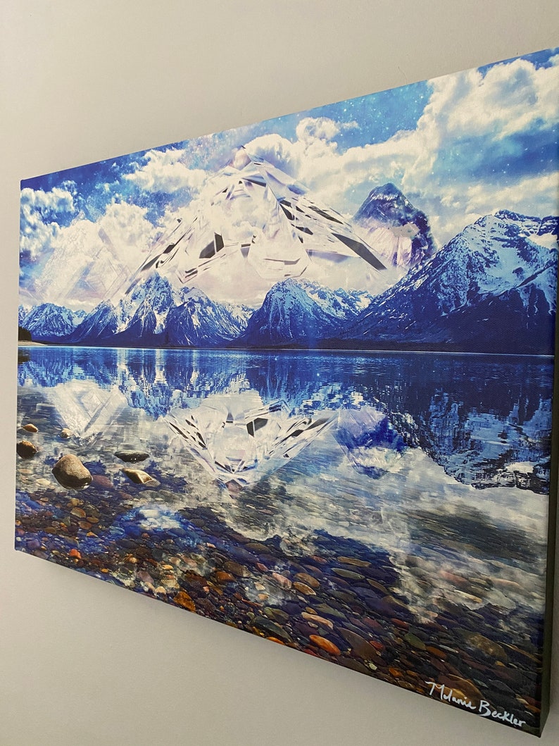 May include: A painting of a snowy mountain range reflected in a still lake. The mountain peaks are white and the sky is blue with white clouds. The lake is a deep blue and the water is calm. The painting is signed "Melanie Beckler" in the lower right corner.