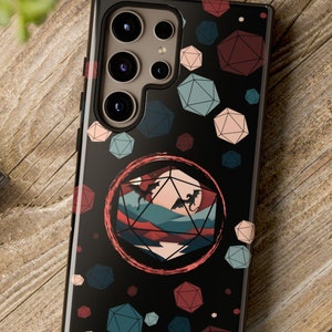 May include: A black phone case with a colorful geometric pattern and a red circle with a mountain landscape and two dragons. The case has a camera cutout with three lenses.