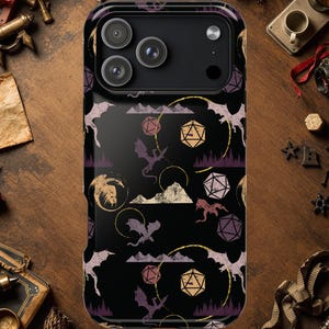 May include: Black phone case with a fantasy-themed design. The case features a repeating pattern of dragons, dice, and mountain silhouettes in shades of purple, gold, and beige. The case has a glossy finish and a camera cutout.