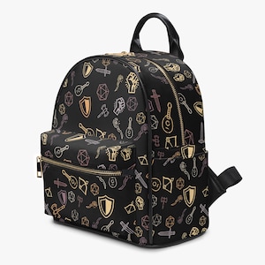 Mini PU leather backpack purse with fantasy RPG icons including dice, swords, shields, and spell symbols on a black background; front zipper pocket and top handle
