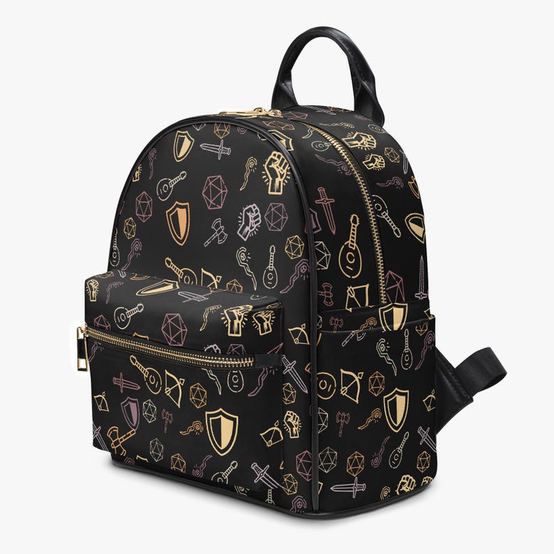 Mini PU leather backpack purse with fantasy RPG icons including dice, swords, shields, and spell symbols on a black background; front zipper pocket and top handle
