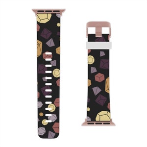 May include: A black and rose gold Apple Watch band with a geometric pattern of colorful diamonds. The band is made of silicone and has a smooth, comfortable feel.