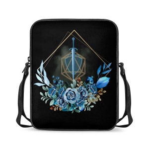 May include: Black shoulder bag with a blue and gold design featuring a sword and a twenty-sided die surrounded by blue flowers.