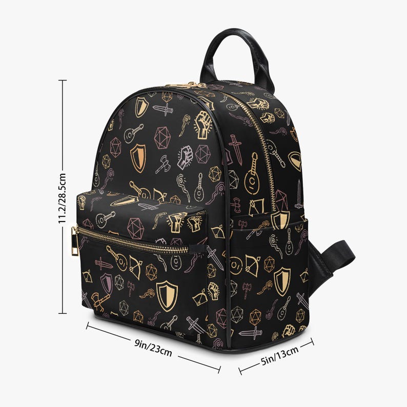 Mini PU leather backpack purse with fantasy RPG icons including dice, swords, shields, and spell symbols on a black background; front zipper pocket and top handle