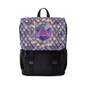 May include: A black backpack with a purple and gold design featuring a large purple and gold dice with a crescent moon pattern. The dice is surrounded by a circle of crescent moons and stars.
