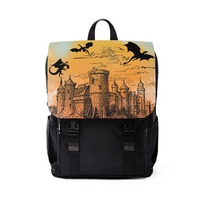 May include: Black backpack with a large pocket on the front. The pocket has a print of a castle with three dragons flying above it. The background is a sunset with orange, yellow, and blue colors.