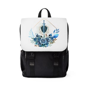 Puede incluir: Mochila negra con un panel frontal blanco que presenta un diseño geométrico azul y dorado con una espada y flores.