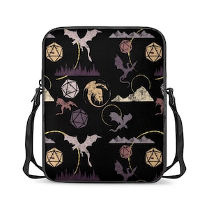 May include: Black crossbody bag featuring a repeating pattern of dragons, dice, and mountain silhouettes in beige, purple, and gold. The bag has a black adjustable strap and a rectangular shape.