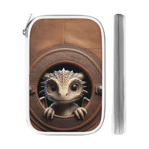 May include: A brown leather-look zippered case with a white border. A cartoon dragon with large eyes and small wings peeks out from a circular opening. The dragon is light brown and tan, with a detailed, textured appearance.
