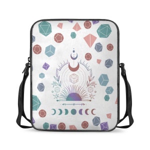 May include: A white laptop sleeve with a black adjustable strap. The sleeve features a repeating pattern of pastel blue, pink, and red geometric shapes. A central design features a sun, moon, and a 20-sided die.
