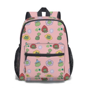 May include: Pink backpack with a repeating pattern of green frogs, yellow lemons, red strawberries, and green four-leaf clovers.