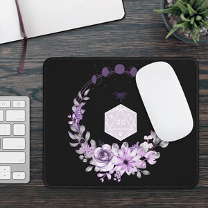 Könnte beinhalten: Schwarze Mauspad mit einem violetten Blumenkranz, einem 20-seitigen Würfel und einem Halbmond-Design.