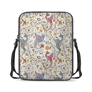 May include: A white laptop sleeve featuring a repeating pattern of colourful dragons and vines. The dragons are in shades of red, blue, and green, and the vines are in shades of yellow and green. The sleeve has a black adjustable shoulder strap.