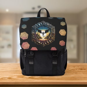 May include: Black backpack with a colourful design featuring a dragon flying in front of a geometric pattern. The pattern includes a variety of colours, including pink, orange, yellow, and blue.