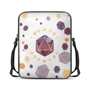 May include: White crossbody bag with a fantasy design. The bag features a large purple geometric shape with dragons and a landscape scene, surrounded by a moon phase design. Scattered around are various geometric shapes in purple and yellow.