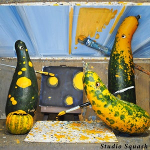 May include: Three gourds painted with yellow dots on a black background. The gourds are green and yellow with black spots. The gourds are holding paintbrushes and are painting on a canvas.