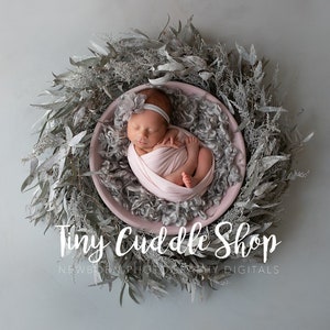Puede incluir: Un bebé recién nacido duerme en un cuenco rosa rodeado de una corona de hojas de eucalipto secas. El bebé está envuelto en una manta rosa y lleva una diadema blanca. El texto "Tiny Cuddle Shop Newborn Photography Digitals" está debajo del cuenco.
