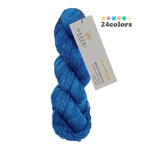May include: A skein of blue yarn with a label that reads "Wool Star Bright Coral 3019" and "Gazal" with a small logo of a shell. The label also says "24 colours".