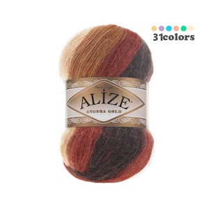 May include: A ball of Alize Angora Gold yarn in a multi-colored pattern of brown, beige, and red. The yarn is soft and fluffy, and it is perfect for knitting or crocheting.