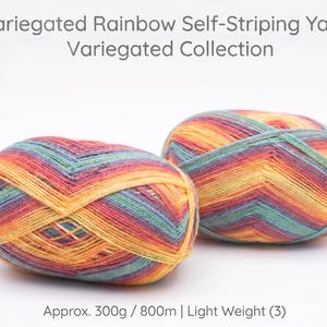 May include: Two balls of variegated rainbow self-striping yarn. The yarn is a mix of colors including orange, yellow, red, blue, and green. The text on the image reads "Variegated Rainbow Self-Striping Yarn Variegated Collection" and "Approx. 300g / 800m | Light Weight (3)".