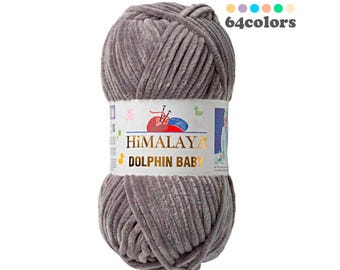 May include: A skein of gray yarn with a soft, fuzzy texture. The yarn is labeled "Himalaya Dolphin Baby" and is available in 64 colors.