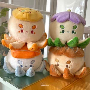 May include: Three plush octopus toys with different colored hats. The first octopus has a yellow hat with a brown swirl design. The second octopus has a purple hat with green leaves. The third octopus has a brown hat with a yellow swirl design.