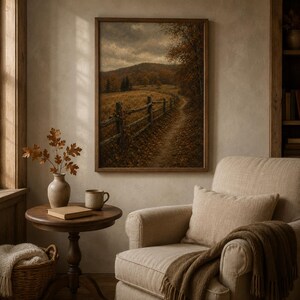 Golden country road with wooden fence and autumn trees art print above a cream armchair — cozy fall decor printable from a 280+ vintage seasonal bundle.