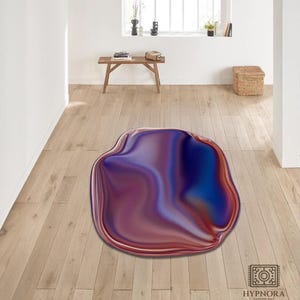 May include: A unique, abstract area rug with a fluid, organic shape. The rug features a blend of colors, including deep blues, purples, and reds, creating a marbled effect. The rug is placed on a light-colored wooden floor, adding a touch of modern art to the room.