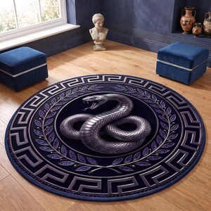 May include: A circular rug featuring a central metallic silver snake coiled within a wreath of purple leaves. The design is framed by a wide border displaying a repeating silver Greek key pattern against a deep navy blue background.