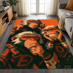 May include: A rectangular area rug featuring a cartoon illustration of three monkeys with orange faces and accents. The monkeys are set against an orange background, wearing dark green and orange patterned clothing. The rug is a unique home decor item.