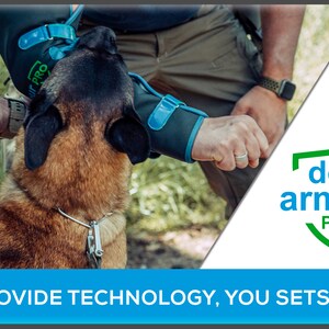 May include: A brown and black dog wearing a blue and green dog armor pro sleeve. The dog is looking up at a person wearing a green shirt and a watch. The text "dog armour PRO" is in a green shield with a white background. The text "WE PROVIDE TECHNOLOGY, YOU SETS LIMITS" is in blue on a white background.