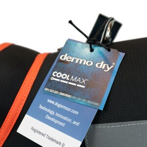 May include: A black dog harness with a bright orange trim and a white tag that says "dermo dry COOLMAX 100% SECO 100% TRANSPIRABLE 100% DRY 100% BREATHABLE www.dogarmour.com Technology, Innovation, and Development Registered Trademark &copy;"