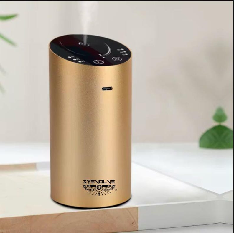 May include: A gold cylindrical diffuser with a black top and a logo that says "XYENOLIVE" with a stylised Egyptian symbol.