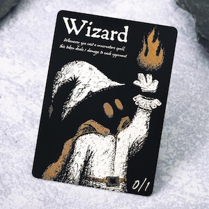 May include: Black card featuring a wizard illustration. The wizard is depicted in a white robe and hat, with a brown cloak. A hand with a white glove is raised, and a flame is above it. Text on the card reads "Wizard" and "0/1".