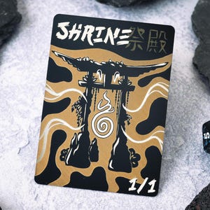 May include: A black and gold card with a white illustration of a Japanese shrine with a spiral symbol inside. The card has the text "SHRINE" and Japanese characters in white. The bottom right corner of the card has the text "1/1".