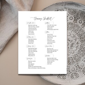 May include: A black and white printable cleaning checklist with a handwritten font. The checklist is divided into sections for different areas of a home, such as the reception area, waiting area, shepper area, back bar, bathroom, stations, wipe chairs, and dorm room. Each section lists specific cleaning tasks to be completed.